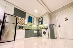 Kitchen and washing machine sophisticated 2br surabaya apartment at via tower