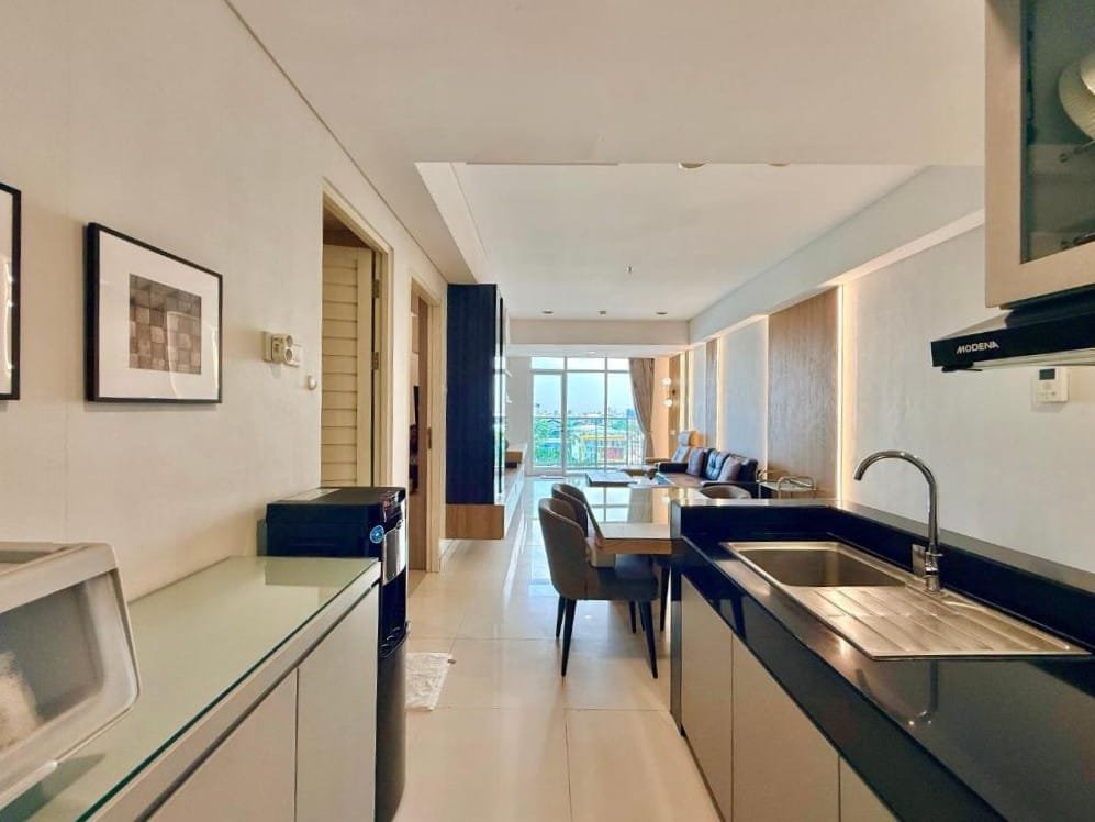 Open living, dining and kitchen area with balcony at Trillium